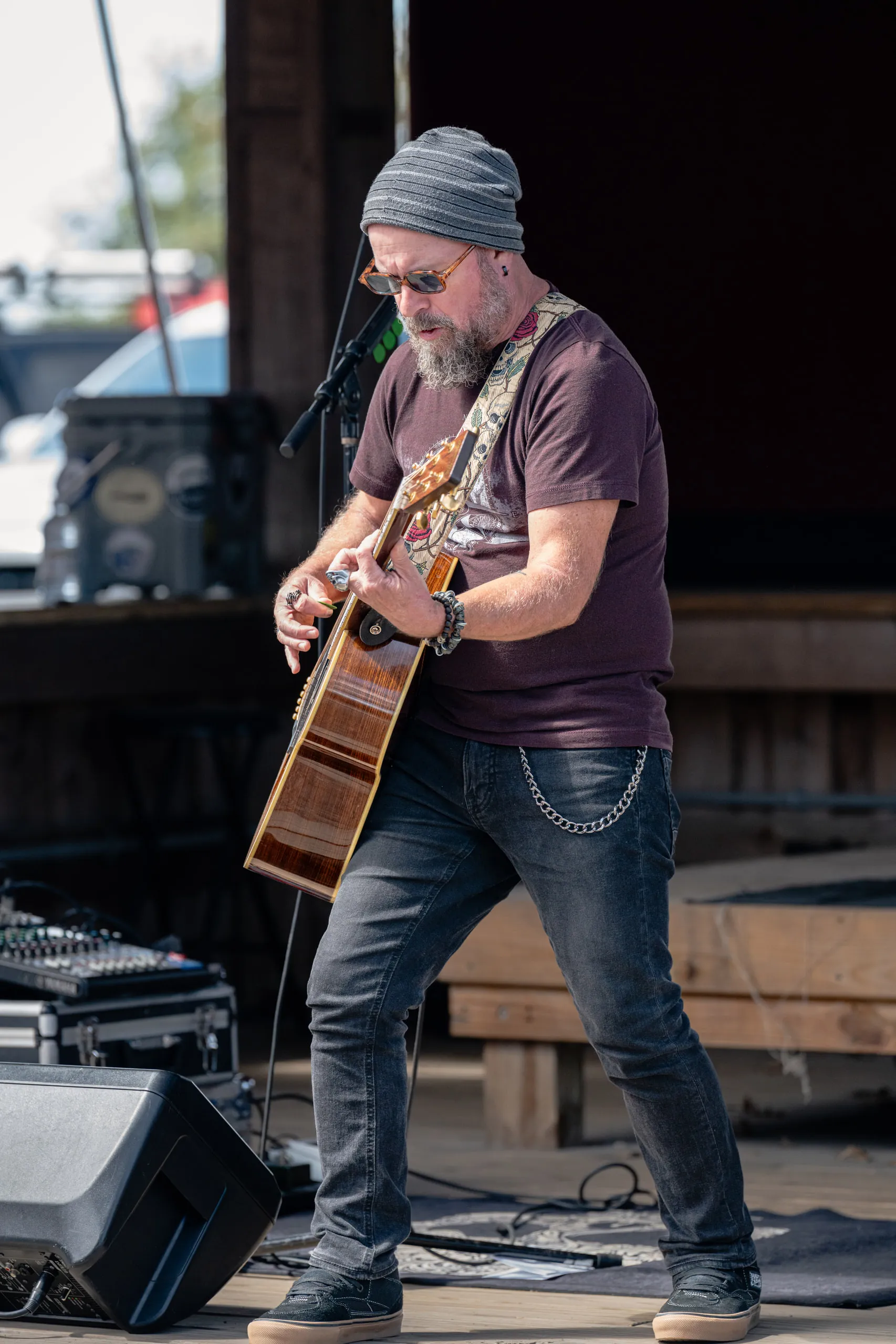 The guitarist works through a song at the microphone stand, amp and monitor behind
